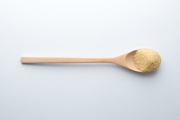 Brown sugar background with wooden spoon