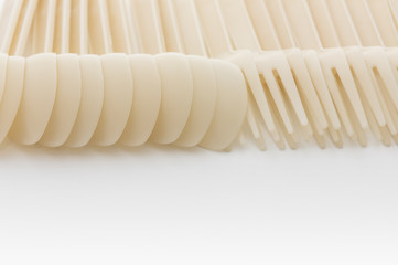 Biodegradable plastic spoon and fork on white background