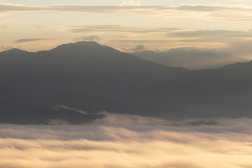 Silhouette of Mountain With Fluffy Clouds during Sunrise
