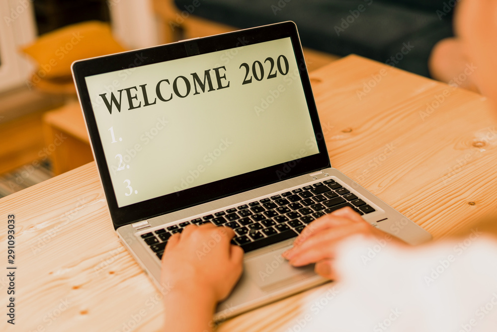 Wall mural Word writing text Welcome 2020. Business photo showcasing New Year Celebration Motivation to Start Cheers Congratulations woman laptop computer smartphone mug office supplies technological devices