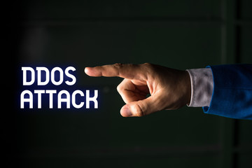 Handwriting text writing Ddos Attack. Conceptual photo perpetrator seeks to make network resource unavailable Isolated hand pointing with finger. Business concept pointing finger