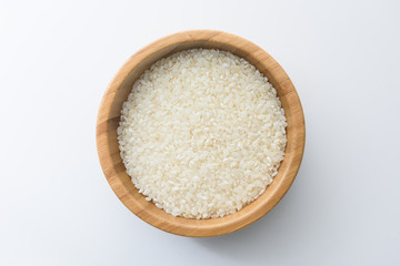 Top view close up of Thai jasmine rice uncook in glass bowl, a long-grain variety of fragrant rice, white background isolate, clipping path