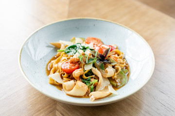 Italian pasta tagliatelle with seafood and tomato sauce. Pasta Gamberini. Parmesan cheese