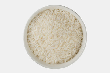 Top view close up of Thai jasmine rice uncook in glass bowl, a long-grain variety of fragrant rice, white background isolate, clipping path