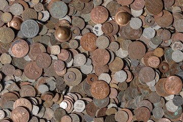 Old vintage fake coins background for sale to tourists in the Indian market on the street in Rishikesh, India. Close up