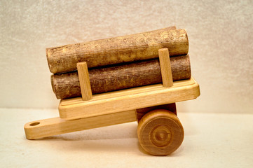 yellow wooden trailer with  bunch of tree brown logs located in the home interior and used for decoration