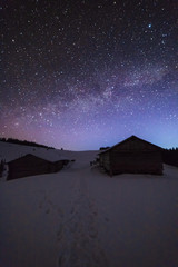 Wonderful night views of the Carpathian winter mountains with millions of stars in the sky and beautiful scenery