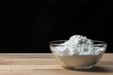 Close-up of flour or starch, Corn starch or tapioca starch powder in glass bowl background isolate