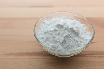 Fototapeta na wymiar Close-up of flour or starch, Corn starch or tapioca starch powder in glass bowl background isolate