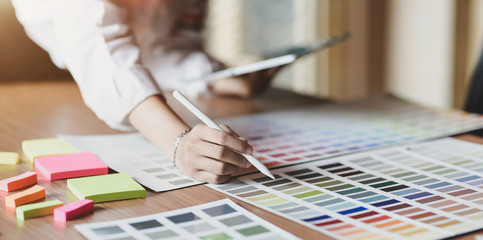 Young professional UI graphic designer choosing colours for their smartphones templates