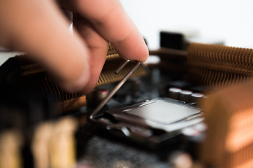 Computer engineer maintenance computer CPU hardware upgrade of motherboard component, PC repair by technician and industry support installation CPU on socket with flare