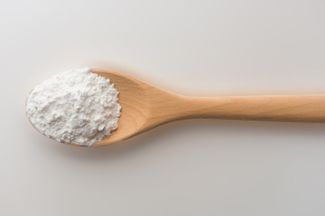 Tapioca starch or flour powder on wooden spoon isolated white background with clipping path