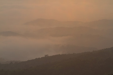 Silhouette of Mountain With Fluffy Clouds during Sunrise