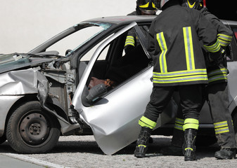 Fototapeta premium firefighters cut the sheets of a damaged car