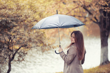 Young girl in a coat in autumn  park