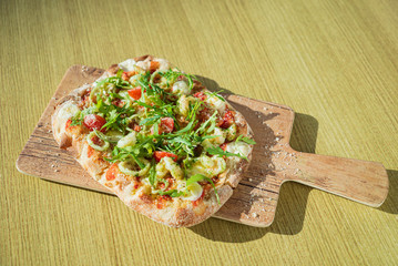 fresh pizza with calamari and arugula