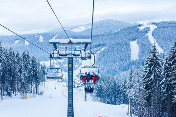 Skiers on chairlift at ski resort
