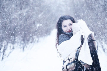 Fototapeta na wymiar Beautiful girl in a beautiful winter snow