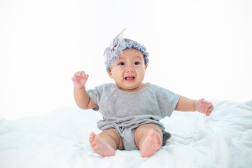 Babies are sad on a white bed.