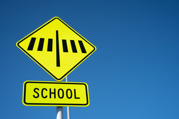 Close Up of a School Crossing Sign Against a Blue Sky