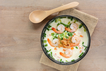 homemade style steamed egg with shrimp and vegetables in a ceramic bowl on wooden table, top view. healthy food concept.