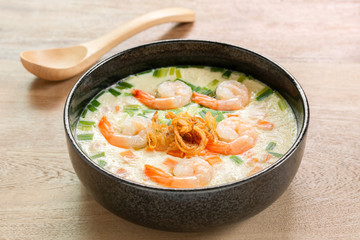 homemade style steamed egg with shrimp and vegetables in a ceramic bowl on wooden table, close up. healthy food concept.
