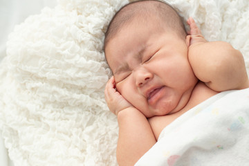 Baby lying on the bed