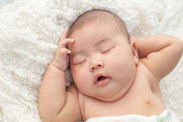 Baby lying on the bed