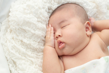 Baby lying on the bed