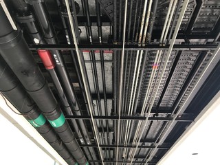 Underground car park service pipings running along the ceiling at a petroleum and gas refining...