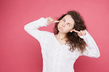 Funny childish  young Caucasian female with funky hair blowing cheeks bursting out, grimacing,...