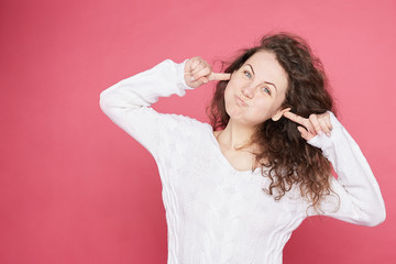Fototapeta premium Pretty childish Caucasian student female with funky hair blowing cheeks bursting out, laughing, having joy, looking happily into camera. Lucky female amazing herself. Positive body language emotions