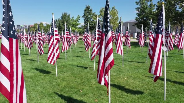 Flying down row of American Flags in park for 9/11 memorial.