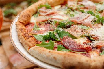 Pizza with prosciutto ham and grated parmesan