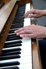 Hands playing the piano close up