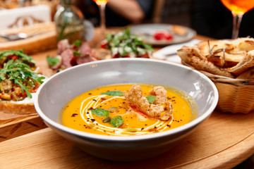 Deep plate with pumpkin soup, Italian restaurant