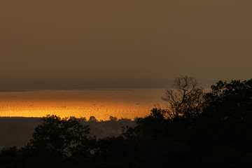 Fototapeta na wymiar Golden sky at sunset on the river