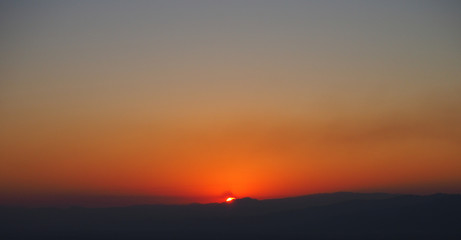Sunset on mountains is a beautiful silhouette background.