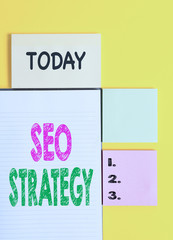 Word writing text Seo Strategy. Business photo showcasing Techniques and tactics to increase the visitors of a website Colored empty papers with copy space on the yellow background table