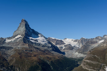 Fototapeta premium Amazing View of the mountain Matterhorn, Zermatt, Valais in the Swiss Alps, blue sky, no clouds in early autumn.