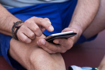 man in the gym using his cellphone