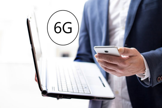6G concept with businessman with his laptop and cellphone