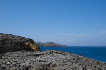 Fototapeta na wymiar Beautiful rock cliff with blue sea in Nusa Penida Island Bali, Indonesia