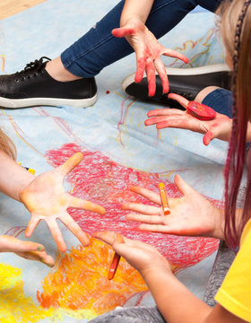 Happy Young Kids Showing Dirty Hands, Diy Visual Arts Lesson At School Arts And Crafts, Artistic Children Painted Hands Drawing Using Pastels Holding Crayons, Messy Colorful Friendly Workspace Concept