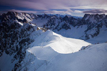 View from Aiguille du Midi, France. Skiers going down on Mer de Glace .