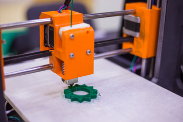 3D printing technology concept - three dimensional printing machine making physical 3D model at...