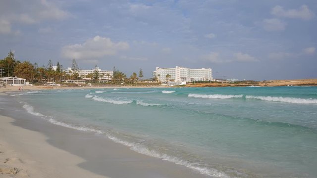 powerful turquoise waves of famous Nissi beach in Cyprus in daytime