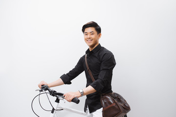 Fototapeta na wymiar Handsome guy standing by bicycle isolated on white