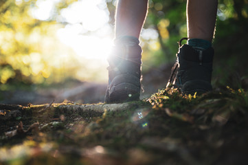 Low angle view of childs legs wearing mountain shoes walking uphill