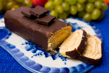 roll on a plate with pieces of chocolate and grapes